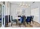 Elegant dining room features an modern table, chairs, lighting, and sliding glass door at 10601 Shady Falls Ct, Riverview, FL 33578