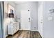 Entryway with a white cabinet, lamp, and coat hooks at 10601 Shady Falls Ct, Riverview, FL 33578
