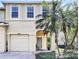Charming two-story home with attached garage, front door, and beautiful landscaping at 10601 Shady Falls Ct, Riverview, FL 33578
