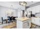 Bright kitchen with stainless steel appliances, central island, dining area, and modern chandelier at 10601 Shady Falls Ct, Riverview, FL 33578