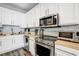 Kitchen featuring stainless steel appliances, wood countertops and white cabinets at 10601 Shady Falls Ct, Riverview, FL 33578