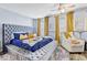 Luxurious main bedroom with a tufted headboard, seating area, and modern decor at 10601 Shady Falls Ct, Riverview, FL 33578