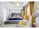 Luxurious main bedroom with a tufted headboard, seating area, and modern decor at 10601 Shady Falls Ct, Riverview, FL 33578