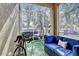 Relaxing screened porch with cozy seating and a hanging chair at 10601 Shady Falls Ct, Riverview, FL 33578