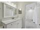 Bathroom with white vanity and large mirror at 10883 Dragonwood Dr, Tampa, FL 33647