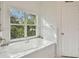 Bathroom featuring a large soaking tub and window at 10883 Dragonwood Dr, Tampa, FL 33647