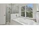 Spa-like bathroom with soaking tub and walk-in shower at 10883 Dragonwood Dr, Tampa, FL 33647