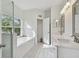 Elegant bathroom with soaking tub, double vanity, and walk-in shower at 10883 Dragonwood Dr, Tampa, FL 33647