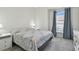 Spacious bedroom with large window and carpeted floor at 10883 Dragonwood Dr, Tampa, FL 33647