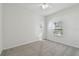 Bright bedroom with gray carpet and a large window at 10883 Dragonwood Dr, Tampa, FL 33647