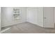 Well-lit bedroom with gray carpet and double door closet at 10883 Dragonwood Dr, Tampa, FL 33647