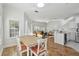 Open concept dining area with hardwood floors and kitchen access at 10883 Dragonwood Dr, Tampa, FL 33647