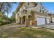 Tan three-story townhouse with a white garage door and stone accents at 10883 Dragonwood Dr, Tampa, FL 33647