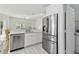 Bright kitchen featuring stainless steel appliances and white cabinetry at 10883 Dragonwood Dr, Tampa, FL 33647