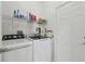 Convenient laundry room with washer, dryer, and shelving at 10883 Dragonwood Dr, Tampa, FL 33647