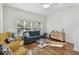 Bright living room with hardwood floors, comfy seating, and large windows at 10883 Dragonwood Dr, Tampa, FL 33647