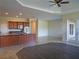 Open concept living room with kitchen view, dark wood flooring, and access to patio at 1109 Toscano Dr, Trinity, FL 34655