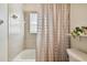 Clean bathroom with tub shower and neutral colors at 11411 Turtle Dove Pl, New Port Richey, FL 34654