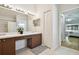 Double vanity bathroom with mirror and access to bedroom at 11411 Turtle Dove Pl, New Port Richey, FL 34654