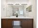 Double vanity bathroom with large mirror and lighting at 11411 Turtle Dove Pl, New Port Richey, FL 34654