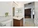 Small bathroom with vanity and view of kitchen at 11411 Turtle Dove Pl, New Port Richey, FL 34654