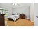 Bedroom with wood floors, window, and ceiling fan at 11411 Turtle Dove Pl, New Port Richey, FL 34654