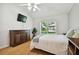 Bright bedroom with wood floors and large window at 11411 Turtle Dove Pl, New Port Richey, FL 34654