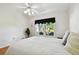 Bright bedroom with a ceiling fan and view of the backyard at 11411 Turtle Dove Pl, New Port Richey, FL 34654