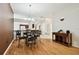 Charming dining room with hardwood floors and a round table with four chairs at 11411 Turtle Dove Pl, New Port Richey, FL 34654