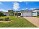 Attractive single-story home with a large front yard and a two-car garage at 11411 Turtle Dove Pl, New Port Richey, FL 34654