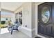 Peaceful front porch with two blue chairs and a view of the yard at 11411 Turtle Dove Pl, New Port Richey, FL 34654