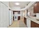 Modern kitchen with white appliances and rich wood cabinets at 11411 Turtle Dove Pl, New Port Richey, FL 34654