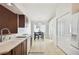 Kitchen with wood cabinets, white appliances, and a dining area view at 11411 Turtle Dove Pl, New Port Richey, FL 34654
