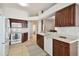 Modern kitchen with white appliances and rich wood cabinets at 11411 Turtle Dove Pl, New Port Richey, FL 34654