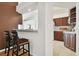 Kitchen features a breakfast bar with two stools and a partial view of the kitchen at 11411 Turtle Dove Pl, New Port Richey, FL 34654