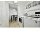 Laundry room with washer, dryer and view of dining area at 11411 Turtle Dove Pl, New Port Richey, FL 34654