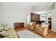 Spacious living room with hardwood floors, armchairs, and a sofa at 11411 Turtle Dove Pl, New Port Richey, FL 34654