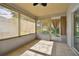Bright sunroom with tiled floors and backyard access at 11411 Turtle Dove Pl, New Port Richey, FL 34654