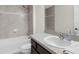 Bathroom with tub, shower, vanity, and dark brown cabinets at 12332 Harris Hawk Rd, Weeki Wachee, FL 34614