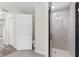 Bathroom with toilet, shower, and a door to another room at 12332 Harris Hawk Rd, Weeki Wachee, FL 34614