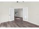 Bedroom with hardwood floors and double doors leading to the living area at 12332 Harris Hawk Rd, Weeki Wachee, FL 34614