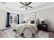 Main bedroom with a ceiling fan and large window at 12332 Harris Hawk Rd, Weeki Wachee, FL 34614