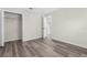 Bedroom with double door closet and grey laminate wood floors at 12332 Harris Hawk Rd, Weeki Wachee, FL 34614