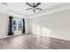 Spacious bedroom with ceiling fan and wood-look floors at 12332 Harris Hawk Rd, Weeki Wachee, FL 34614