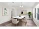 Bright dining room with hardwood floors and modern light fixture at 12332 Harris Hawk Rd, Weeki Wachee, FL 34614
