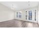 Bright entryway with hardwood floors and glass front door at 12332 Harris Hawk Rd, Weeki Wachee, FL 34614