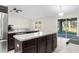 Kitchen with island, stainless steel appliances and backyard view at 12332 Harris Hawk Rd, Weeki Wachee, FL 34614