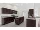Modern kitchen featuring dark wood cabinets and granite countertops at 12332 Harris Hawk Rd, Weeki Wachee, FL 34614