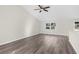 Spacious living room with hardwood floors and large windows at 12332 Harris Hawk Rd, Weeki Wachee, FL 34614