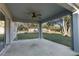 Covered patio with ceiling fan, overlooking backyard at 12332 Harris Hawk Rd, Weeki Wachee, FL 34614